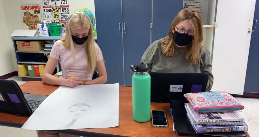 Natalie Nelson (left) and Helena Kohlhoff (right) finish up homework during 2+.