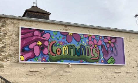 A colorful community mural is visible outside the pantry.