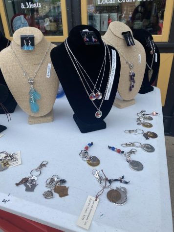 Norwegian coin necklaces,  key chains, and other jewelry Guzman sold during Syttende Mai .