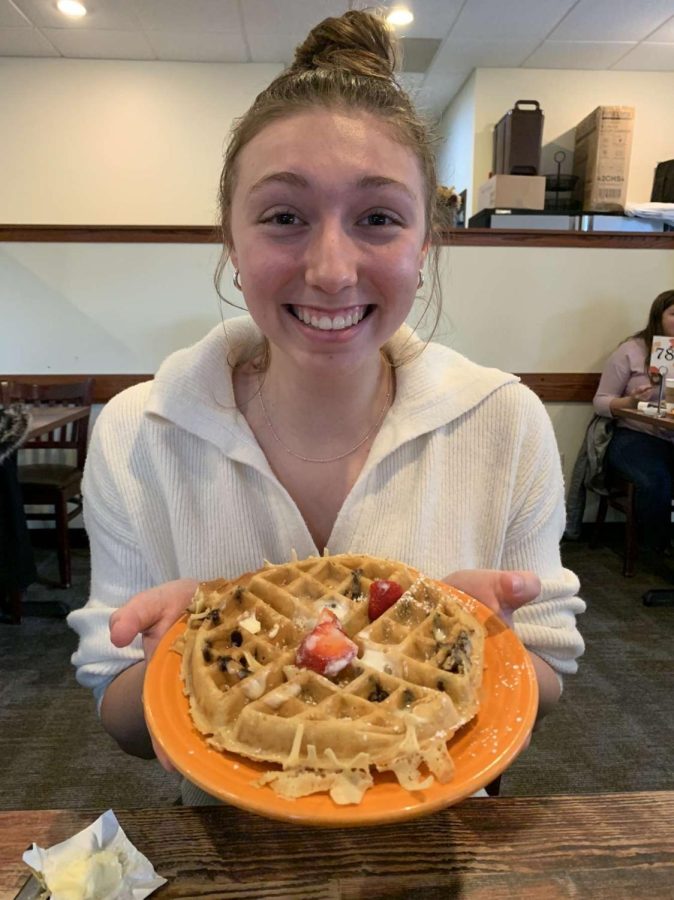 Amstadt excitedly poses with her chocolate chip waffle.