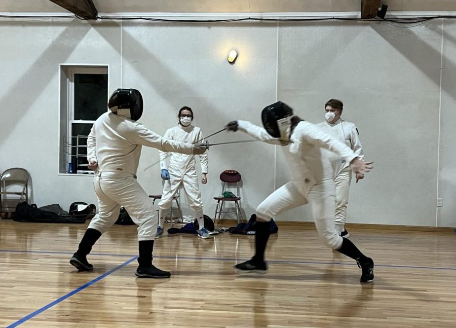 Two+fencers+practice+during+a+meet.