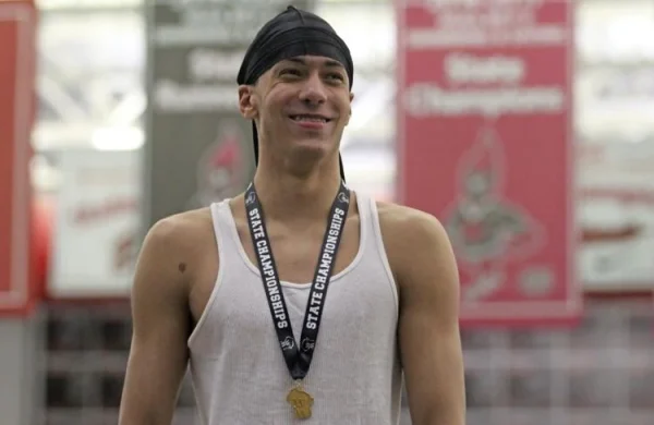 SHS junior Julian Callendar stands on the podium after defending his state champion title in the 100-yard breaststroke at the WIAA Division II state championship on Feb. 16.