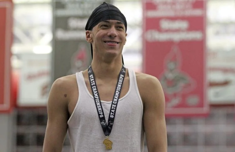 SHS+junior+Julian+Callendar+stands+on+the+podium+after+defending+his+state+champion+title+in+the+100-yard+breaststroke+at+the+WIAA+Division+II+state+championship+on+Feb.+16.